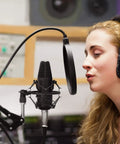 Person using XLR Condenser Microphone Cardioid Studio Kit With T20 Boom Arm Shock Mount And Pop Filter for recording in studio