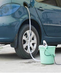 Plug And Play Mini 12V Fuel Transfer Pump With Heavy Duty Stainless Housing And Quick On Off Switch For Moving Diesel Oil Or Water Straight From Drums Or Cans connected to a car fuel tank.