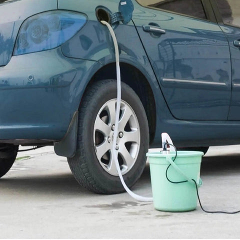 Plug And Play Mini 12V Fuel Transfer Pump With Heavy Duty Stainless Housing And Quick On Off Switch For Moving Diesel Oil Or Water Straight From Drums Or Cans connected to a car fuel tank.