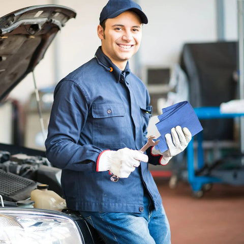 Mechanic holding Blue Huck Towels 50 Pack Bulk Absorbent Cotton Shop Towels 25.2 By 16.93 Inches in auto shop