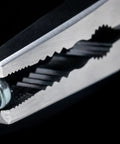 Close-up of Caiman 7.5 Inch Stripped Screw Extractor Needle Nose Pliers With Wire Cutter Crimper holding a screw, made in Japan