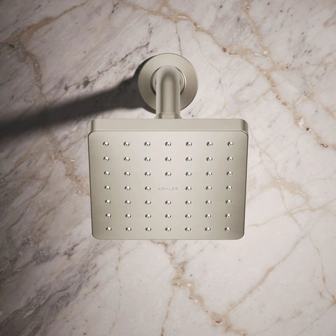 Parallel Single Function Showerhead With 1.75 GPM Flow, 5 Inch Diameter, Katalyst Spray Technology displayed on a marble wall