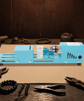 This Badass Mini Wood Lathe Is The Ultimate Desktop Turnin' Tool For Your DIY Crafts. Portable blue wood lathe with copper motor.