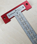 Heavy Duty Scriber T Square Ruler With Support Lips And Built In Scribe Notches Crafted From Rock Solid 301 Stainless Steel Plus Sturdy Aluminum Handle To Nail Every Carpenter Layout Job And Architectural Plan 12 Inch on wood surface.