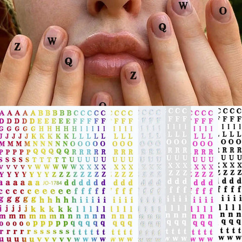 Alphabet nail art stickers on nails and a sheet of colorful letter stickers.