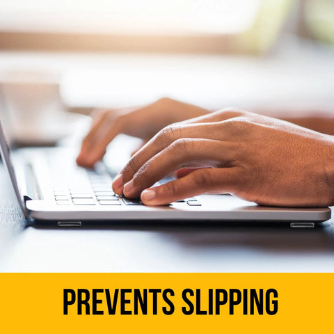 Hands typing on a laptop keyboard with text 'Prevents Slipping' below, illustrating the benefit of using Clear Self Adhesive Cabinet Bumpers 128 Pack For No More Slams Rubber Door And Drawer Cushions Quiet Close And Surface Protection For Cabinets Cupboards Glass Tops Picture Frames And Kitchen Furniture.