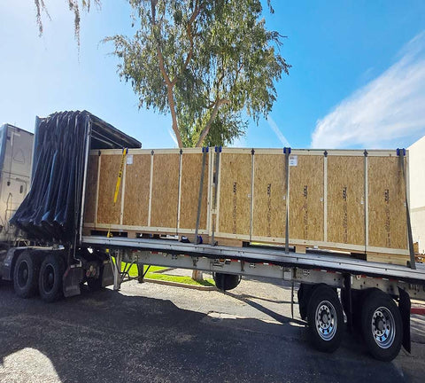 Flatbed truck with boxes secured using 20 Pack 4 Inch Edge Protectors For Flatbed Trucks With Mesh Carrying Case, Yellow Plastic Corner Guards