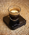 Exagram Pro Coffee Scale with Timer and Carrying Box Smart Espresso Scale showing espresso cup with digital readout on wicker surface