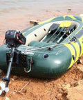Powerful 3.5HP 2 Stroke Outboard Motor with Water Cooling System attached to inflatable boat on rough riverbank