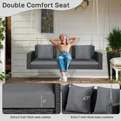 5 Foot Outdoor Porch Swing For Adults Wicker 3 Person Patio Swing with Cushions and Pillow, showing woman seated with reinforced chain.
