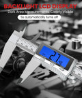 Six Inch Digital Caliper With Rechargeable Battery Backlit LCD Screen Stainless Steel Measuring Tool For 3D Printing DIY And Household Use Auto Off Quick Charge In Inch Millimeter And Fraction Conversion USB Charge Cable showing measurement in dim light