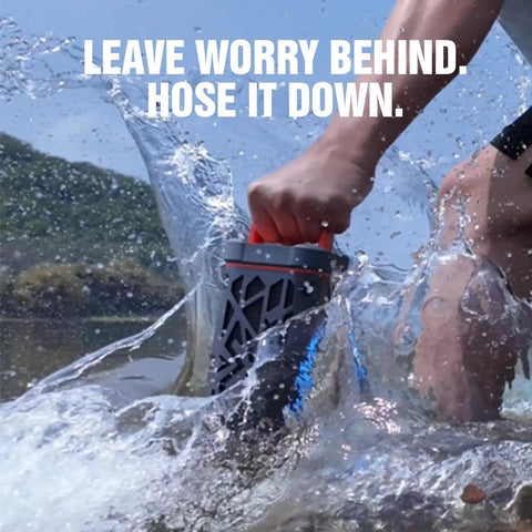 Person holding Rugged Aluminum Bluetooth Speaker With 45W Power, BassUp Enhanced Bass, IP68 Waterproof in splash of water