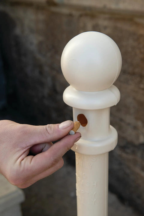 Person disposing into Outdoor Smokeless Cigarette Butt Receptacle In Galvanized Steel With Lid 5 Gallon Capacity 40 Inch Tall Beige