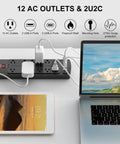 6-Foot Heavy Duty Extension Cord Power Strip With 12 AC Outlets And 4 USB Ports, 2700 Joules Surge Protector, ETL Listed, Black on desk with laptop and tablet