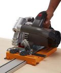 Rip Guide With Saw Plate And Rip Handle For Circular Saws in use, cutting sheet material, showing precision and grip.