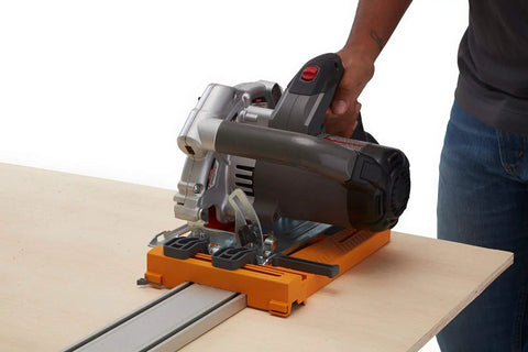 Rip Guide With Saw Plate And Rip Handle For Circular Saws in use, cutting sheet material, showing precision and grip.
