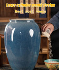 Grab This Solid Ceramic Rice Container With a Tight Seal, Heavy Duty 25kg Grain Dispenser for Your Kitchen Grub Stash, Blue White Porcelain Tea Coffee Bean Jar with a large cylinder mouth design, pouring rice.