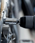 Close-up of a socket being used on a bicycle part from the Beefy All In One Heavy Duty 264 Piece Mechanics Tool Set