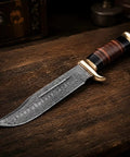 Damascus Steel Bowie Knife With Full Tang Fixed Blade For Tactical Hunting And Camping, shown on wooden table