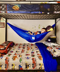 Kid Friendly Camping Hammock For Indoors And Outdoors in a child's bedroom near bunk bed, blue color with toys inside.