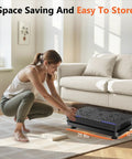 Woman storing Vibration Plate Fitness Platform For Full Body Workout And Lymphatic Drainage Home Gym Shaker Machine under sofa