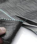 Close-up of Heavy Duty Woven Weed Control Fabric 6 by 33 Feet Black Ground Cover Membrane being cut with scissors