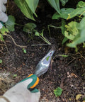 Ergo Weeder Tool For Weeding, Heavy Duty Gardening Hand Tool With Ergonomic Handle removing weed from soil in garden.