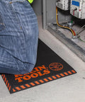 Tradesperson kneeling on Heavy Duty Kneeling Pad For Trades Pros With Handy Handle Large Soft Thick Closed Cell Foam Knee Cushion 1 Inch NBR Foam For All Day Comfort And Long Lasting Protection On Worksites.