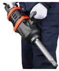 Professional Grade One Inch Air Impact Wrench Built Like A Tank To Handle Heavy Duty Tasks With 5175 Foot Pounds Breakaway Torque For Semi Trucks Buses And Shop Floor Mechanics Featuring An Eight Inch Extended Reach Anvil in use, showing handle and anvil.