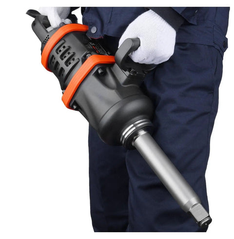 Professional Grade One Inch Air Impact Wrench Built Like A Tank To Handle Heavy Duty Tasks With 5175 Foot Pounds Breakaway Torque For Semi Trucks Buses And Shop Floor Mechanics Featuring An Eight Inch Extended Reach Anvil in use, showing handle and anvil.