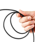Person holding black braided cable from 96 Ft Braided Cable Sleeve Kit With Heat Shrink Tubes for Audio and Video Cables Expandable Wire Loom
