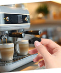 Person holding Heat Resistant Rubber Steam Wand Guard For Coffee Machines, Insulation Sleeve For Burn Prevention in kitchen