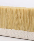 Close-up of the Clean Sweep Cnc Vacuum Brush 100Mm By 1M Length For Milling And Engraving Gear bristles on canvas base.