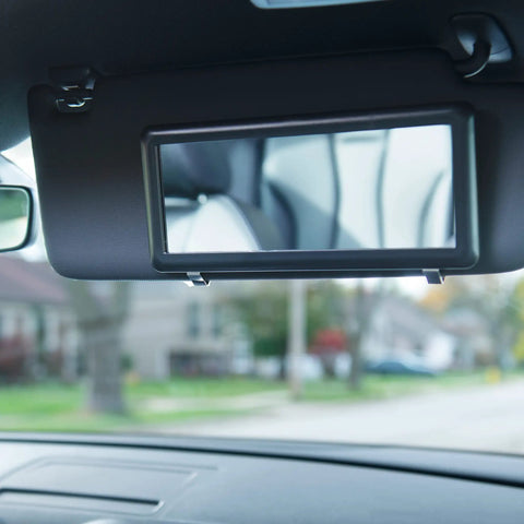 Car Sun Visor Mirror Black Deluxe Makeup And Cosmetic Mirror with Universal Fit for Cars Trucks and SUVs in use.