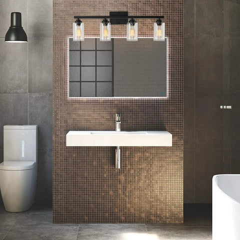 Black 4-light vanity wall sconce with clear glass shades over mirror in modern bathroom, showcasing vintage industrial style.
