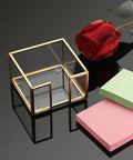 Gold Trimmed Glass Sticky Note Holder With Non Slip Pads For 3x3 Inch Notes, elegant post it dispenser on black surface, with rose and pads.