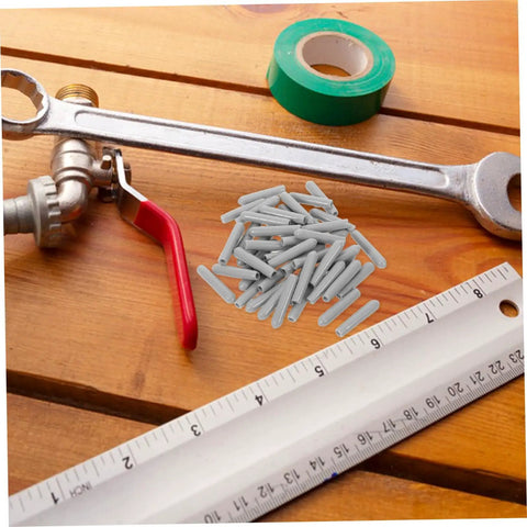 Huge Pack Of Dishwasher Rack End Caps And Tine Protectors Featuring A Hell Of An Easy Snap Installation For Modern Kitchens Solid Heavy Duty Replacement Parts That Really Fix Peeling Or Snapped Pegs In A Jiffy placed on a wooden table with tools.