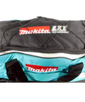 Beefy Wheeled Tool Duffel Bag With Slick Rollers And Rock Solid Handles For Portable Contractor Gear Transport And Massive Jobsite Storage Solutions, top view showcasing black and teal design with Makita branding.