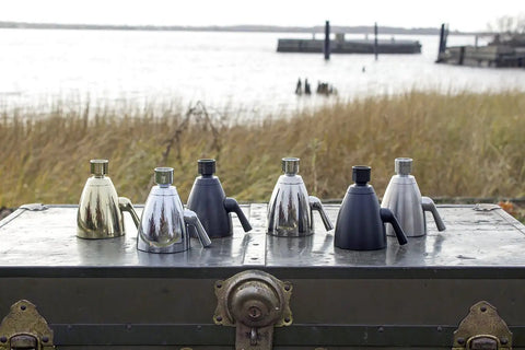 Polished solid brass and other shower heads with Anystream technology on a trunk by a waterfront