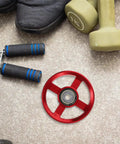 Two Pack Aluminum Gym Pulley Wheels Replacement For Home Gym Systems with red pulley on carpet near dumbbells and hand grips