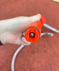 Manual Oil Transfer Pump Portable Siphon With Flexible Hose handheld close-up showing red pump head and hose