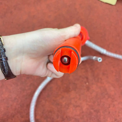 Manual Oil Transfer Pump Portable Siphon With Flexible Hose handheld close-up showing red pump head and hose