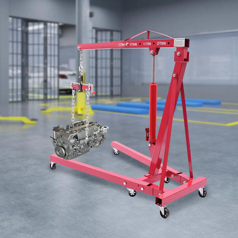 Heavy Duty Two Ton Hydraulic Engine Hoist With Smart Leveler And Folding Cherry Picker Shop Crane Lift Built Like A Tank supporting an engine.