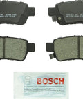 QuietCast Premium Ceramic Disc Brake Pad Set For Honda Odyssey Rear With Quiet Braking Low Dust Formula depicted with lubricant pack