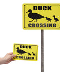 Metal duck crossing sign with large and small versions in yellow, featuring duck silhouettes, for outdoor use