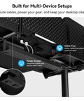 Modular Electric Standing Desk Featuring Expandable L Shaped Layout For Makers And Tech Crews. Cable management and power access details.
