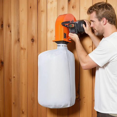 Man operating Wall Mount Dust Collector With 1 HP Motor Delivers 560 CFM For Woodworking Shops, Includes 2.5 Micron Bag installed on wall