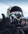 Findway OTG ski goggles with white frame and mirrored lens worn on a snowy slope by a skier in a black beanie