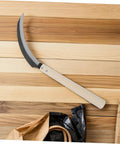 Serrated Weeding Tool With Wooden Handle For Easy Weeding And Harvesting In The Home Garden And Field on wooden surface