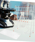 Built Tough White Metal Laboratory Bottle Drying Rack With Thirty Two Pegs For Test Tubes And Glassware beside a microscope.